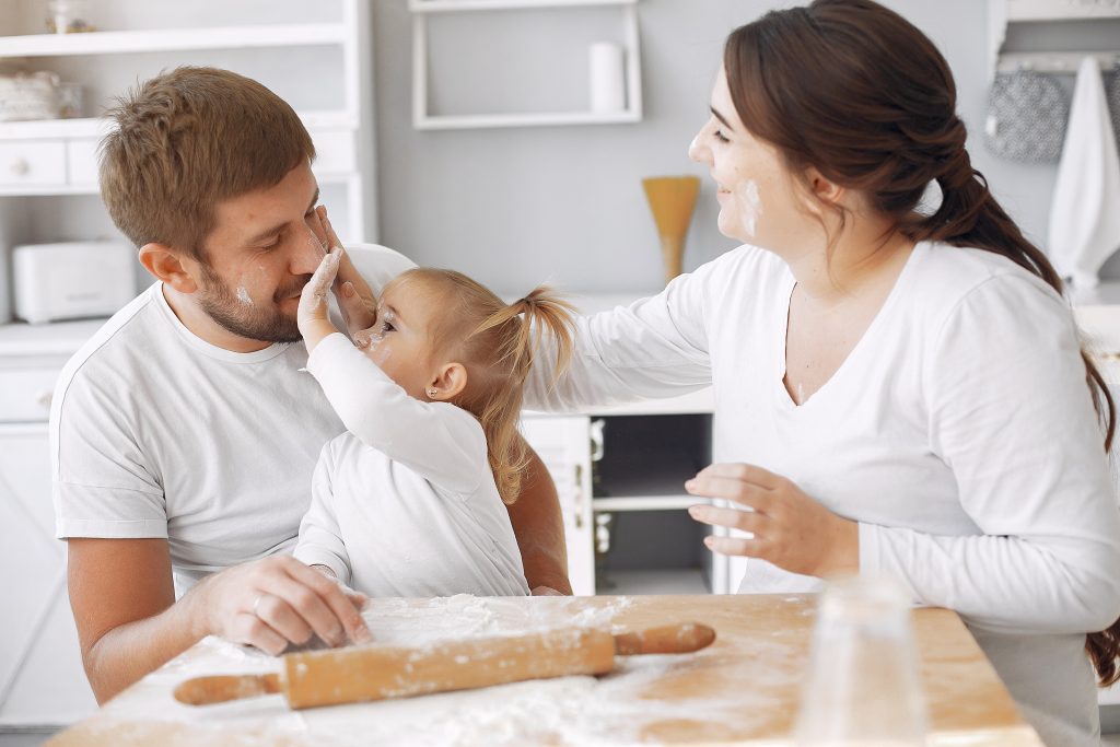 Family in a kitchen. Beautiful mother with little daughter. Family at home