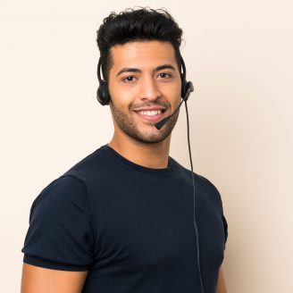 Young handsome man over isolated background working with headset